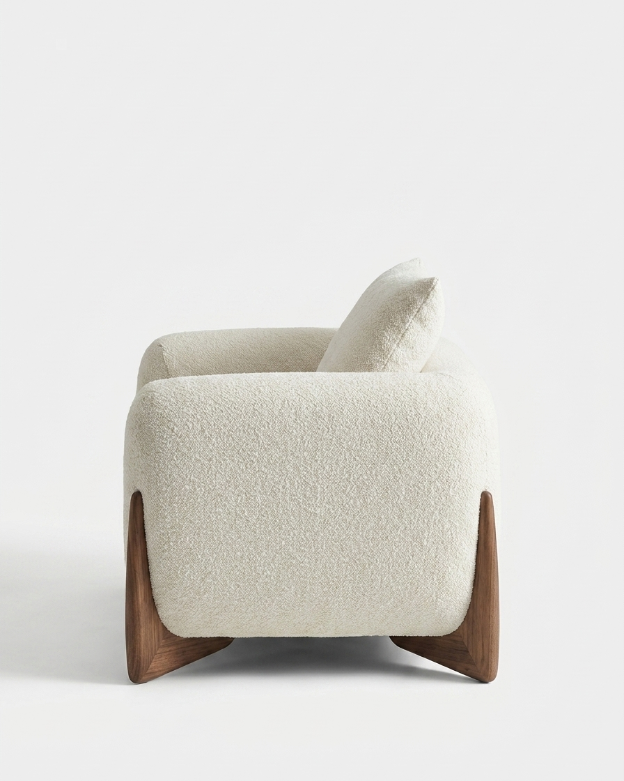 White armchair with wooden legs on a light gray background
