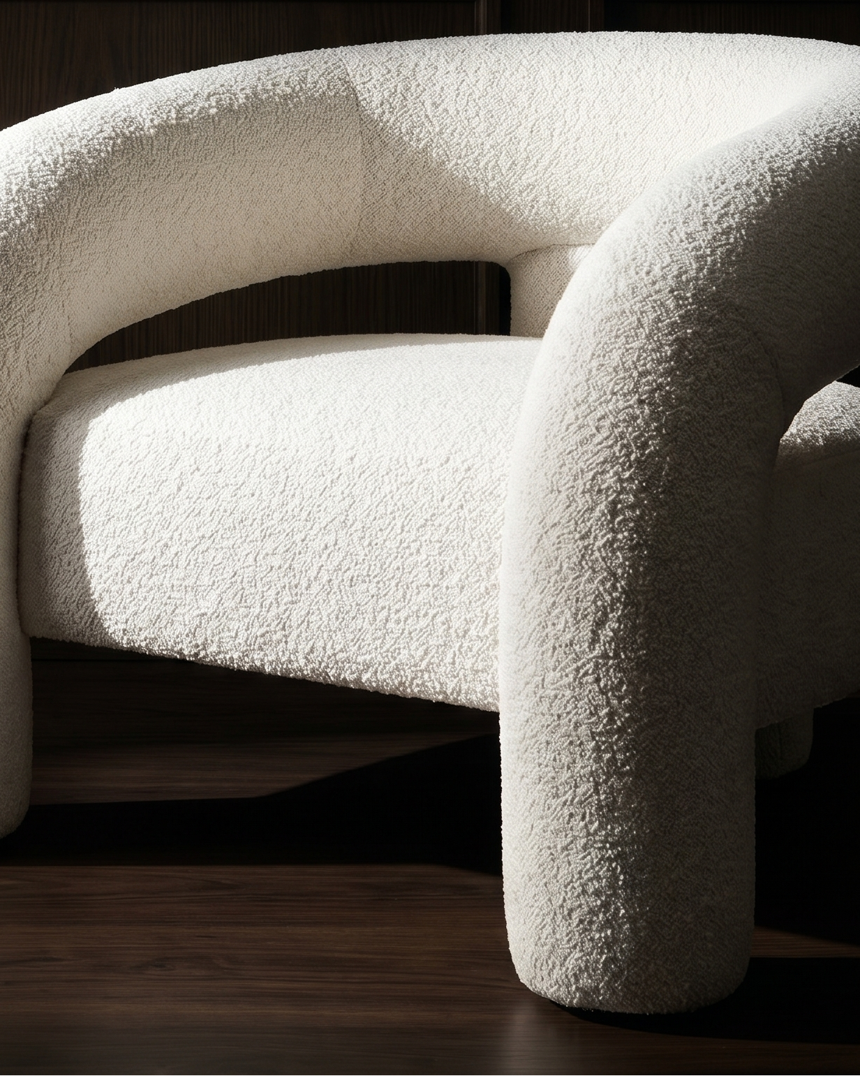 White textured chair against a dark wooden panel background