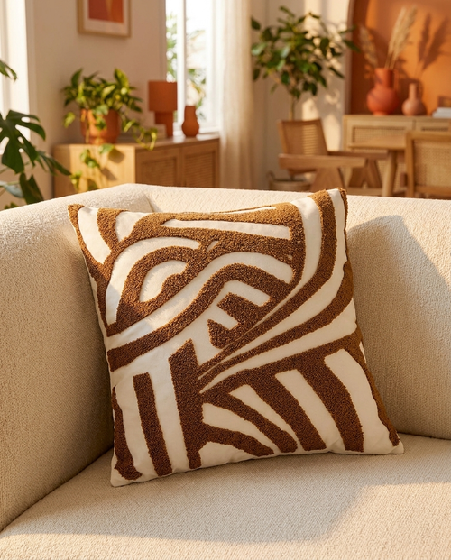 ARLO Knit Pillow in Oatmeal, styled on a beige couch in a living room