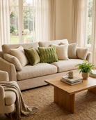 Cozy living room with beige sofa, wooden coffee table, and decorative pillows.