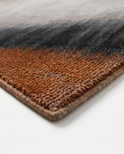 Gradient rug with brown, black, and gray colors on a white background