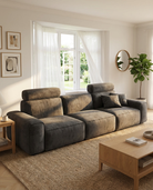 Brown sectional sofa in a living room with a coffee table and decorative items.