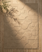 Beige textured wall panel with geometric pattern on a stone wall background
