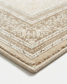 Close-up of a beige and white patterned rug on a light background