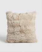 Beige fluffy pillow on a light gray background