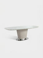 Modern dining table with marble top and metal base on a white background