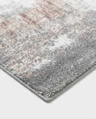 Gray area rug with a subtle pattern on a white background