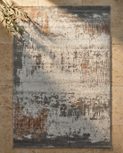 Textured area rug with abstract pattern on a stone floor