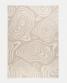 Beige and white patterned rug on a plain background