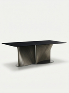 Modern black dining table with a unique base design on a white background