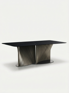 Modern black dining table with a unique base design on a white background