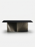Modern black dining table with a unique base design on a white background