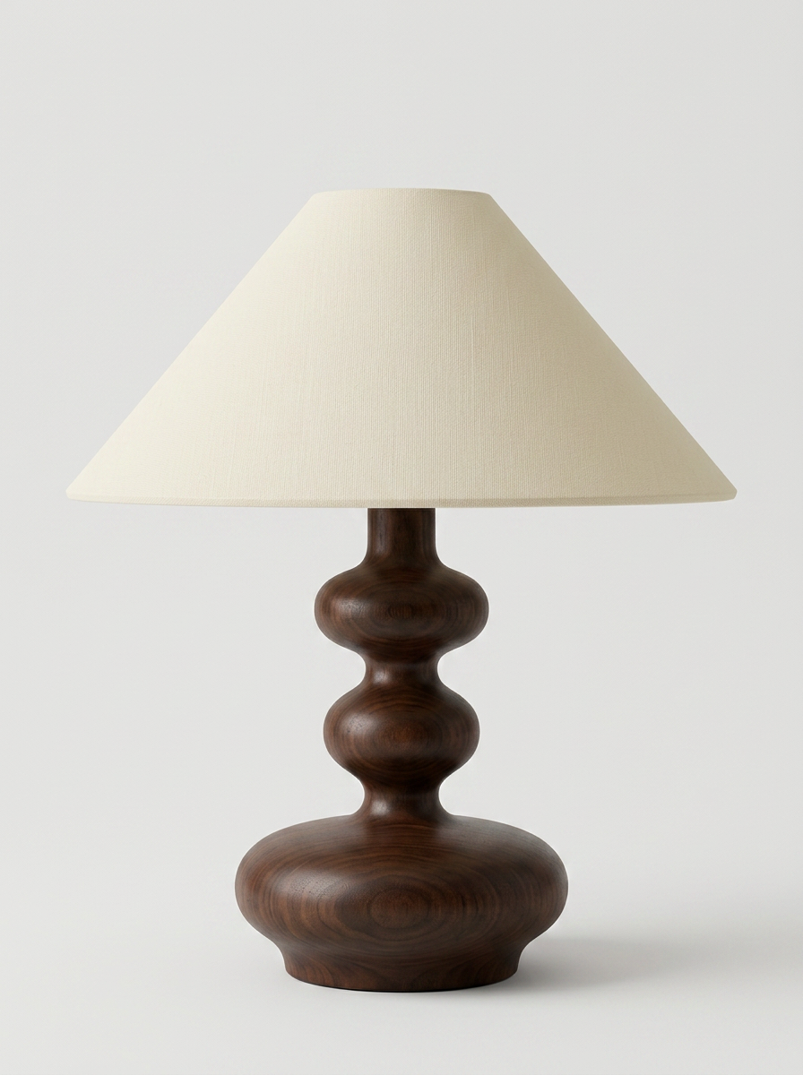 Tra table lamp with sculpted walnut wood base and cream linen shade