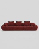 Red sofa with cushions on a light gray background