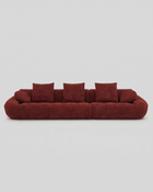Red sofa with cushions on a light gray background