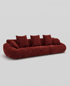 Red sofa with cushions on a light gray background