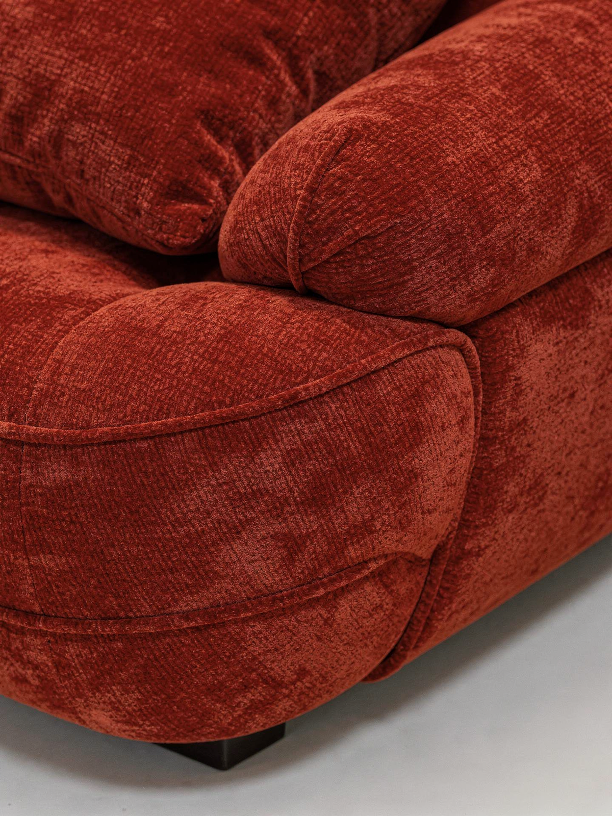 Velor Sculptural Velvet Curved Sofa in Terra Rust, close-up detail of velvet cushion