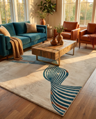Living room with a blue sofa, wooden coffee table, and patterned rug.